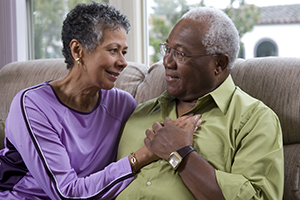 Man and woman sitting on couch.